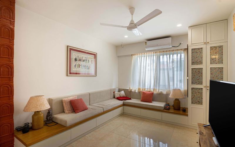 Modern living room showcasing a couch, television and fan, reflecting the expertise of an interior designer in Bangalore.