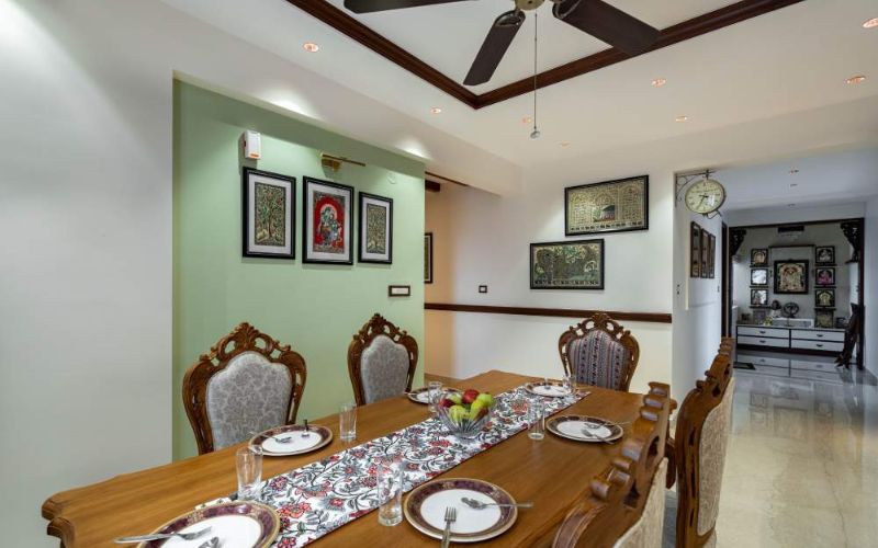 Classic, timeless, traditional dining room with ceiling fan and table.