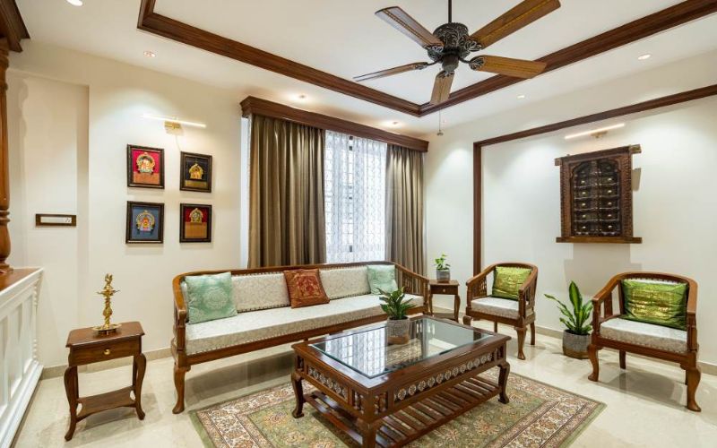 A well-designed living room with wooden furniture and a ceiling fan.