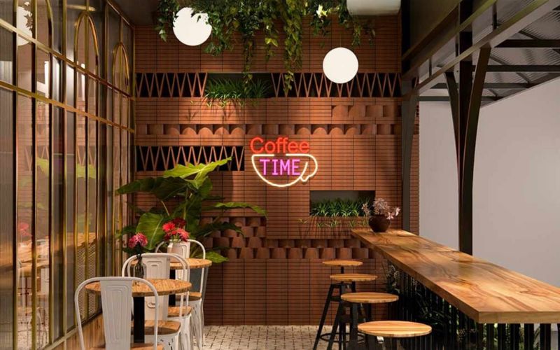 Interior of a Bangalore cafe with rustic wooden tables and chairs, creating a welcoming atmosphere for diners.