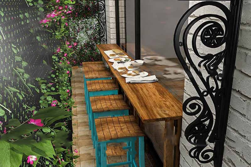 A stylish patio featuring a table and chairs, designed by an interior designing company in Bangalore.