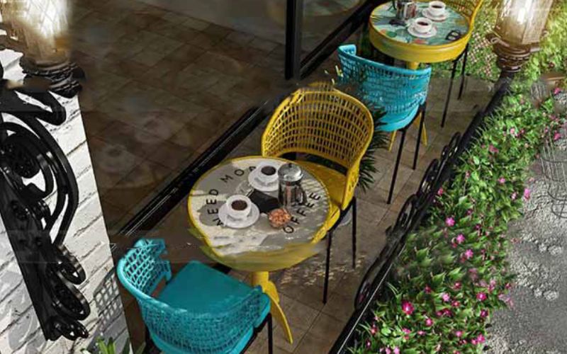 Colorful outdoor patio with chairs and tables, perfect for relaxing and entertaining guests. Ideal for an interior designing company in Bangalore.