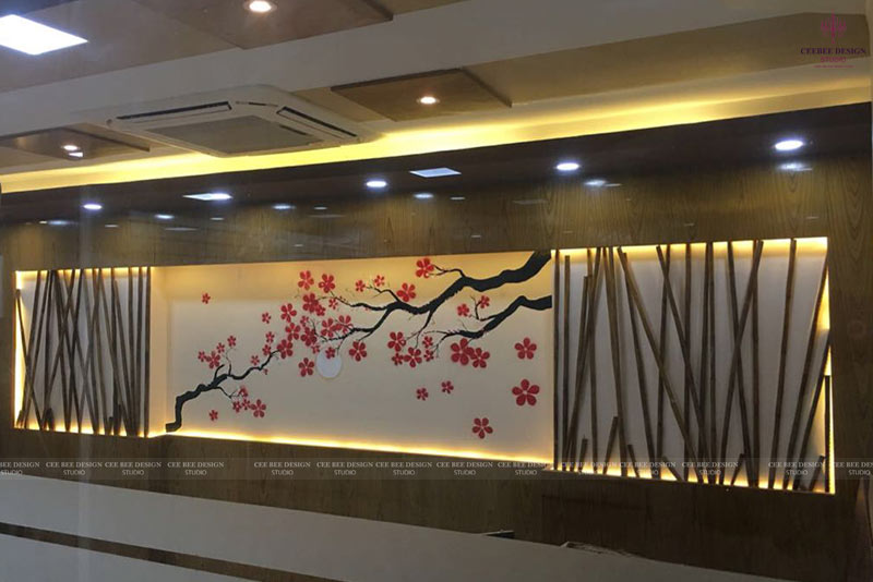 A modern corporate office interior with a large cherry blossom wall mural.