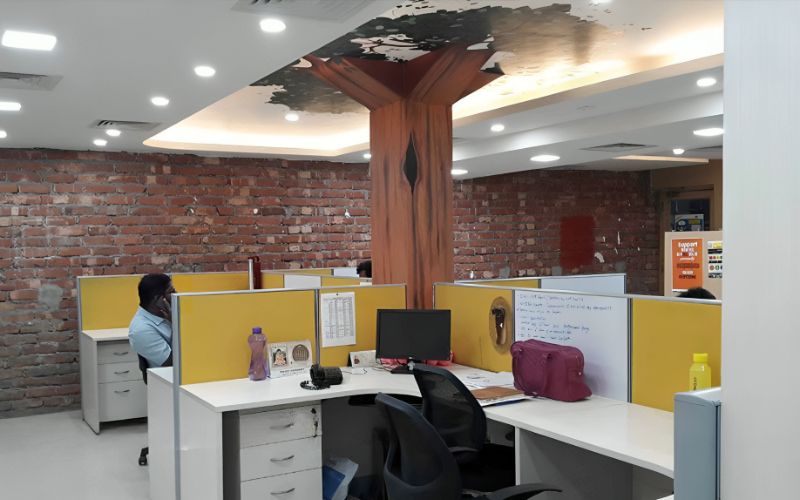 An office space featuring a central tree, showcasing innovative interior design by decorators in Kolkata.