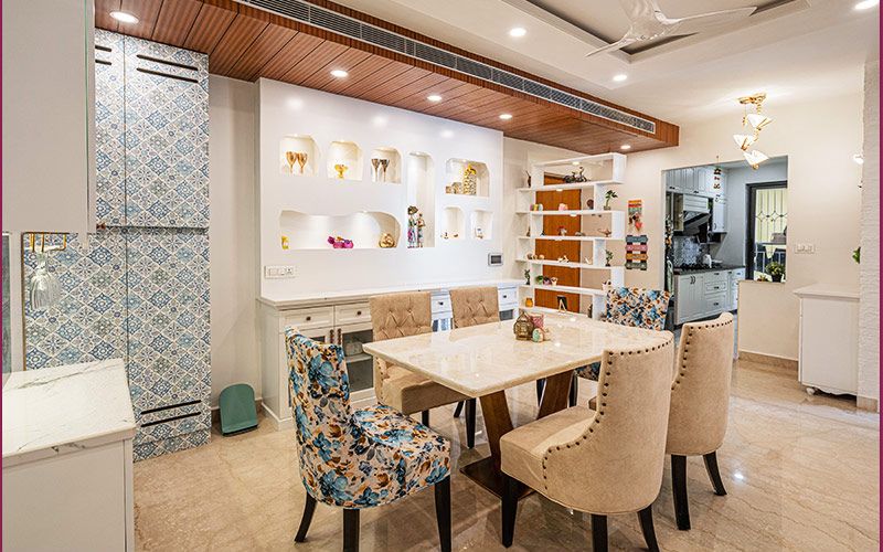 A stylish living room featuring a couch, television, and coffee table, designed by home interior designers in Bangalore.