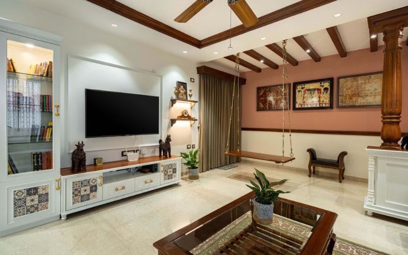Interior designer in Kolkata created a living room with TV, wooden furniture, and ceiling fan.