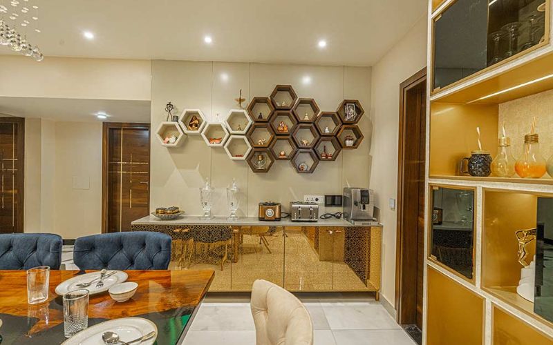 Elegant dining room featuring a gold and white theme, showcasing sophisticated interior design by decorators in Kolkata.