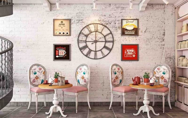 A cozy cafe in Bangalore featuring a white brick wall and a stylish clock, creating a warm and inviting atmosphere.