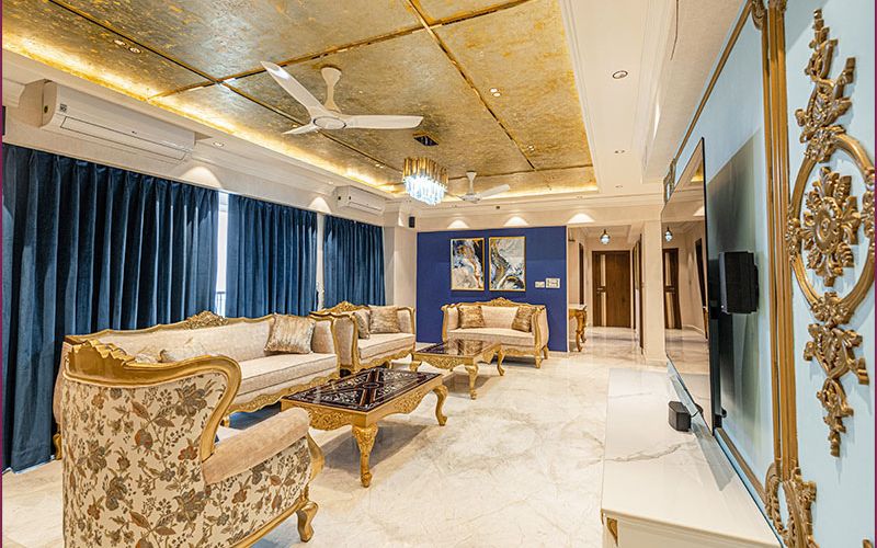 Interior design of 3bhk apartment living room with gold and blue decor.