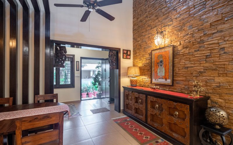 A stylish home interior showcasing a wooden table and chairs, complemented by a ceiling fan for a comfortable ambiance.