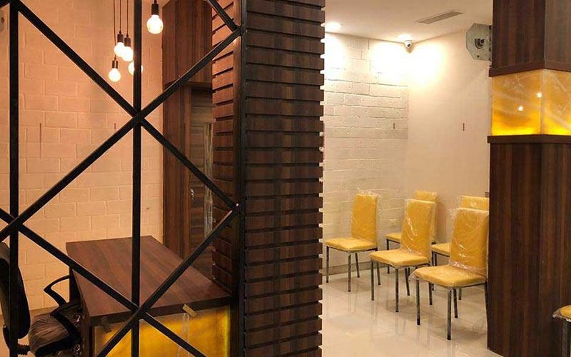 A jewellery store interior in Kolkata featuring yellow chairs and a table, creating a vibrant and inviting atmosphere.