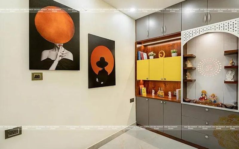 A modern home with a vibrant wall and a stylish cabinet. Includes a mandir design.