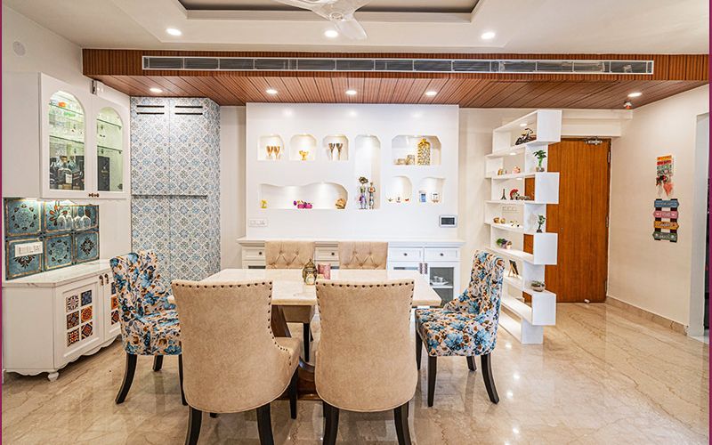 Elegant dining room with a white table and chairs, reflecting contemporary interior design trends in Bangalore homes.