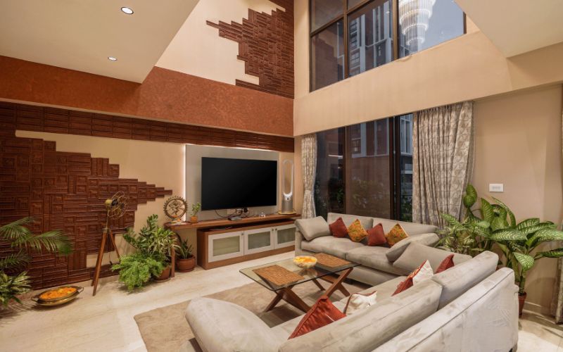 Elegant living room showcasing a comfortable couch and a television, crafted by top interior designers in Kolkata.