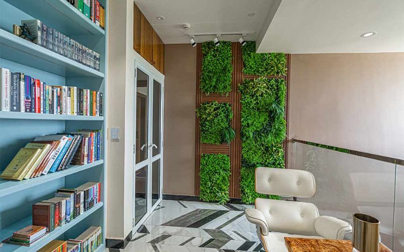 A lush living wall brings life to a modern home office, reflecting the expertise of Kolkata's interior decorators.