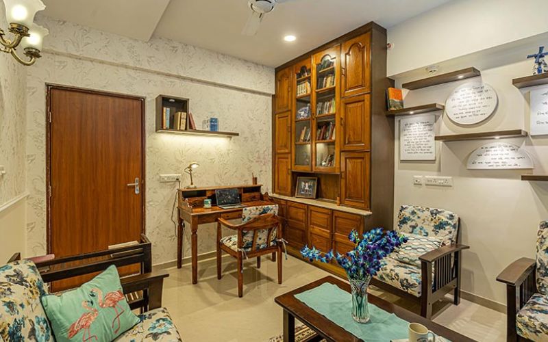 Elegant living room showcasing white walls and wooden flooring, crafted by a Kolkata interior designer.