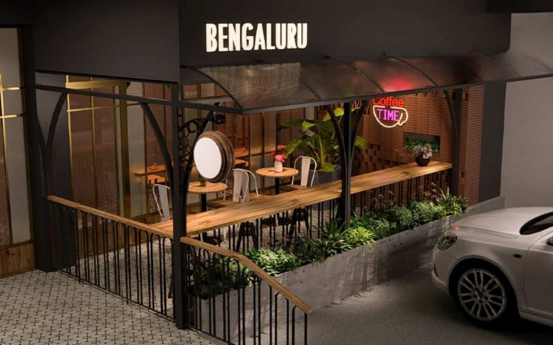 A vehicle stationed outside a Bangalore restaurant, highlighting the cafe's modern interior design.