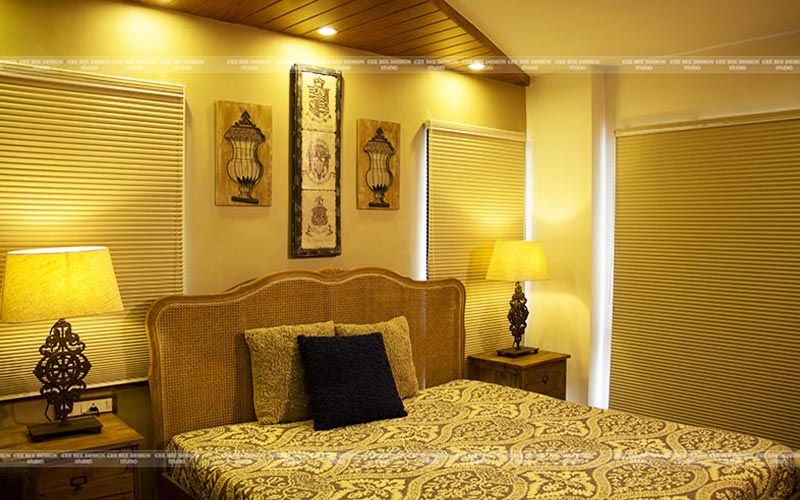 A bedroom adorned with a bed, lamp, and window, demonstrating the significance of lighting in interior design.