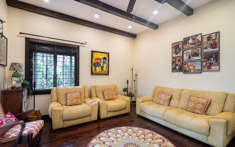 A contemporary living room showcasing bright yellow couches and a decorative rug, crafted by expert home interior designers.