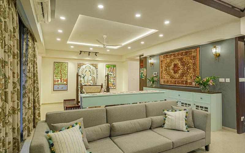 Elegant living room design with a couch, coffee table, and artistic wall decor, reflecting the talent of Bangalore's best designers.