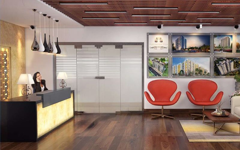 A contemporary office interior featuring a reception desk and seating area, designed by an interior designer in Bangalore.