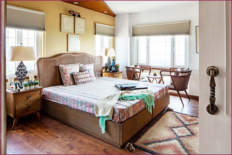 An English style bedroom showcasing a bed, a desk, and a window, crafted by an interior designer based in Kolkata.