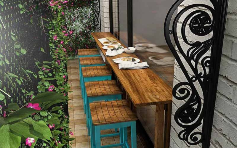 A cozy outdoor dining area featuring a table and chairs, designed for a cafe in Bangalore.