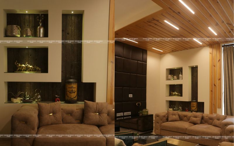 A stylish living room featuring a modern couch and a wall shelf, designed by an interior designer in Bangalore.