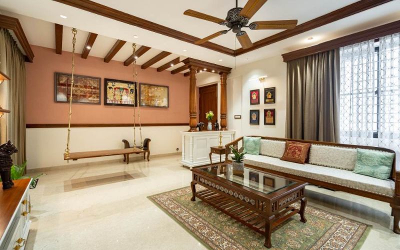 Stylish living room with a swing and ceiling fan, exemplifying the work of luxury interior designers in Bangalore.