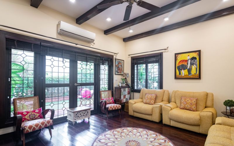 Kerala design style living room with exposed brick pillar and decorative elements.