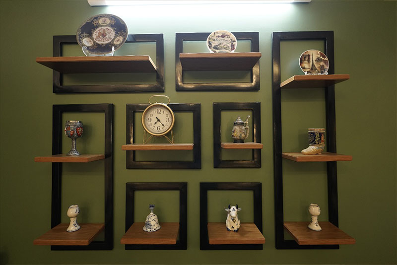 A wall with shelves displaying a variety of items.