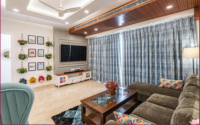 A beautifully designed living room with blue and white decor, exemplifying the creativity of home interior designers in Bangalore.