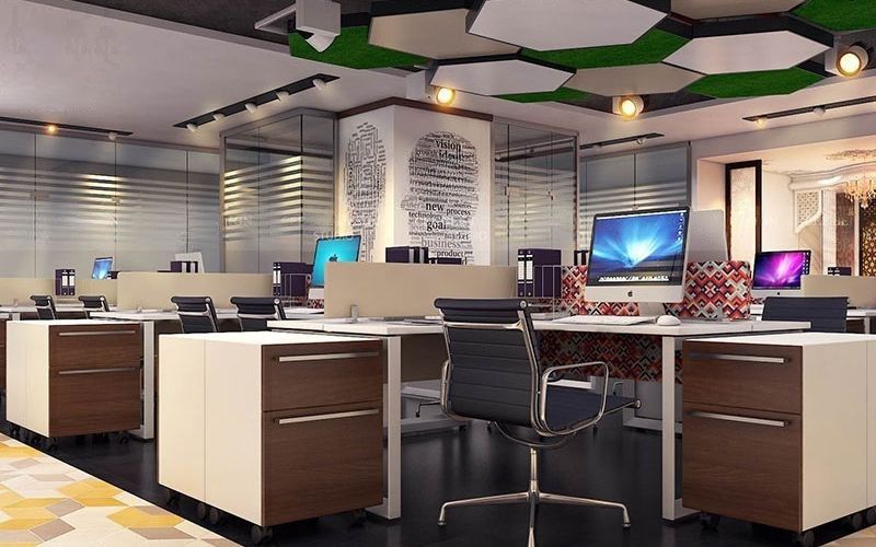 Contemporary office environment with desks and computers, designed by expert interior designers in Bangalore.