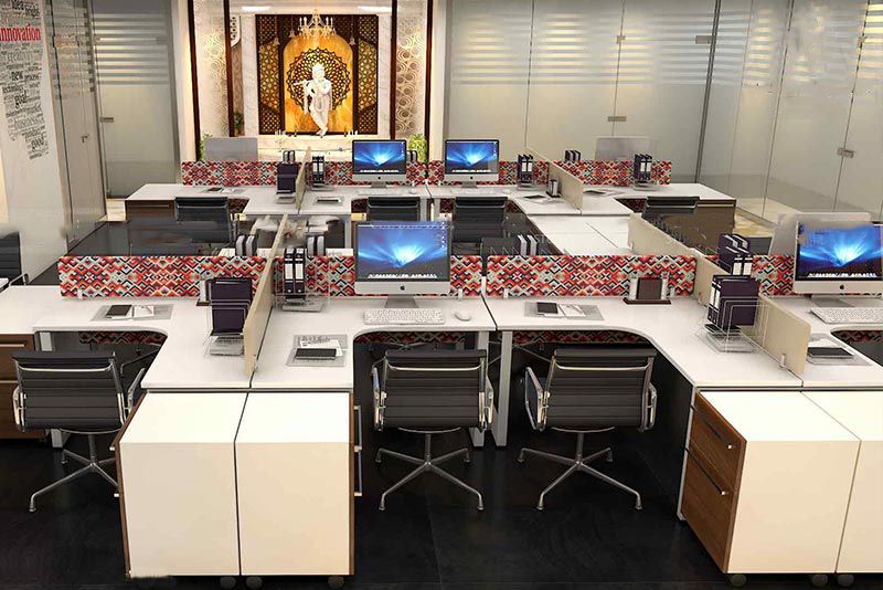 A modern office space featuring desks and computers, designed by top interior designers in Bangalore for optimal productivity.