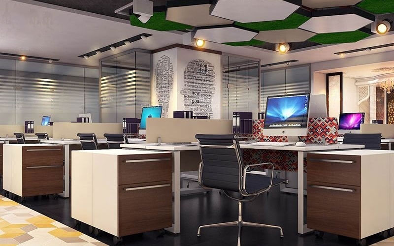 A well-organized office space showcasing desks and computers, crafted by a Kolkata-based interior designer.