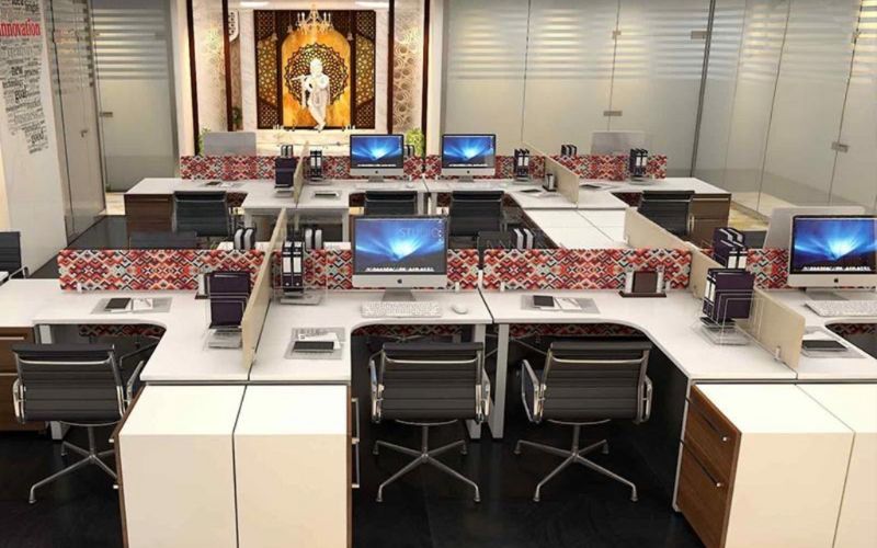 Contemporary office space showcasing desks and computers, crafted by a Kolkata-based interior designer.