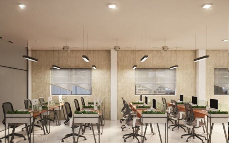 Contemporary office layout with desks and chairs, designed by an interior designer from Kolkata.