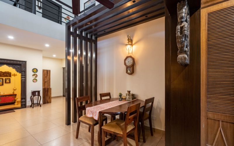 Karelian interior style dining area with wooden slats partition, brick wall decor and a red wooden cupboard.