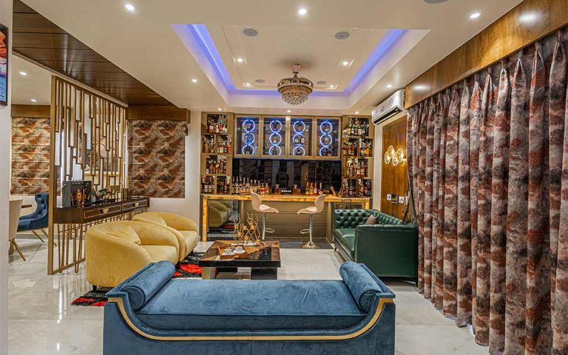 A stylish living room featuring a comfortable couch and a television, showcasing modern interior design trends in Kolkata.